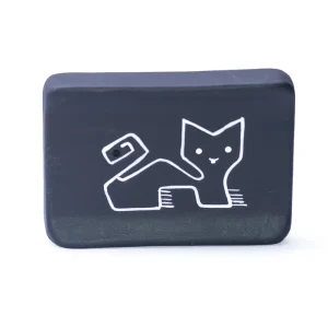 Solid palo santo stick resting on handmade ceramic Puma holder with Andean design